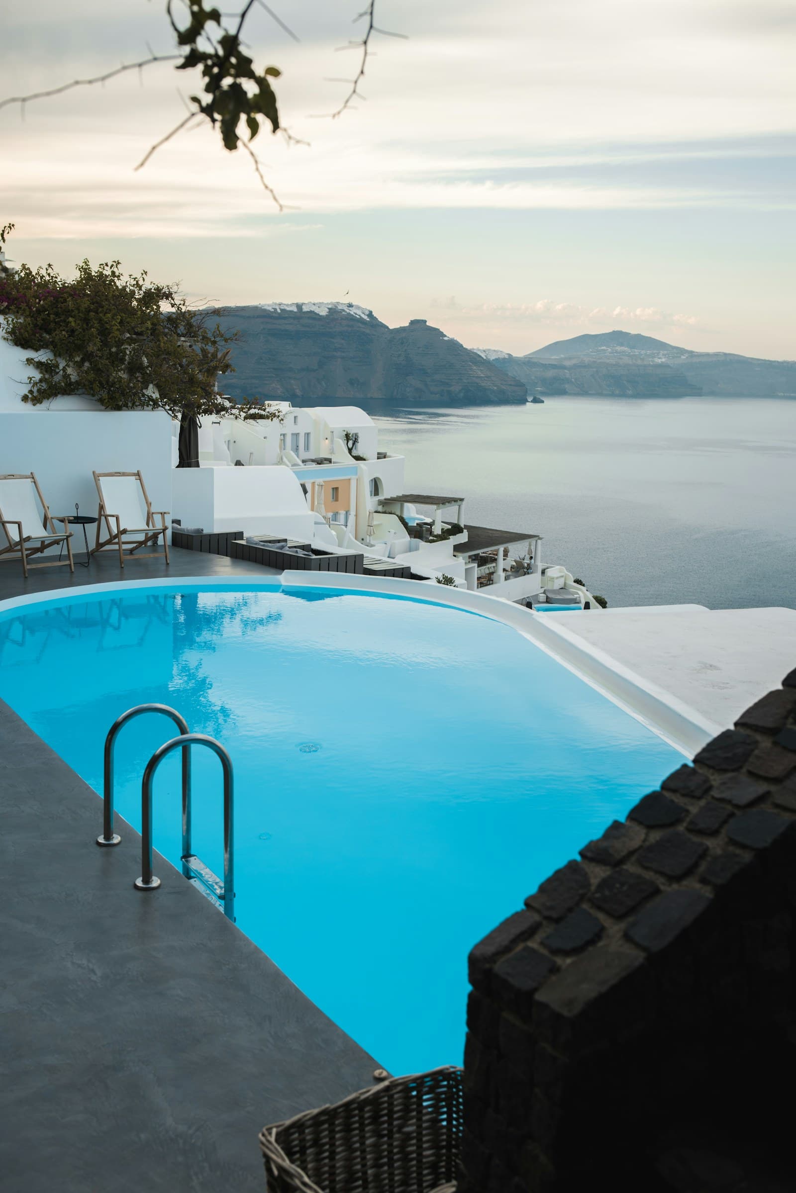 Infinity pool overlooking white coastal buildings